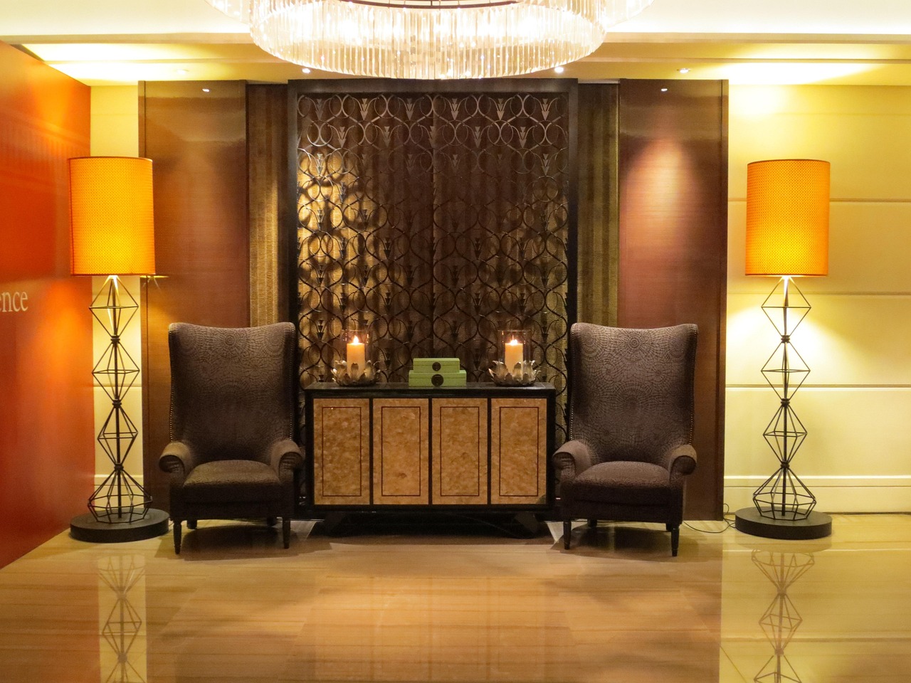Elegant hotel lobby with crystal chandelier, designer furniture, geometric floor lamps, and luxurious textured wall treatments in Virginia Beach, Virginia