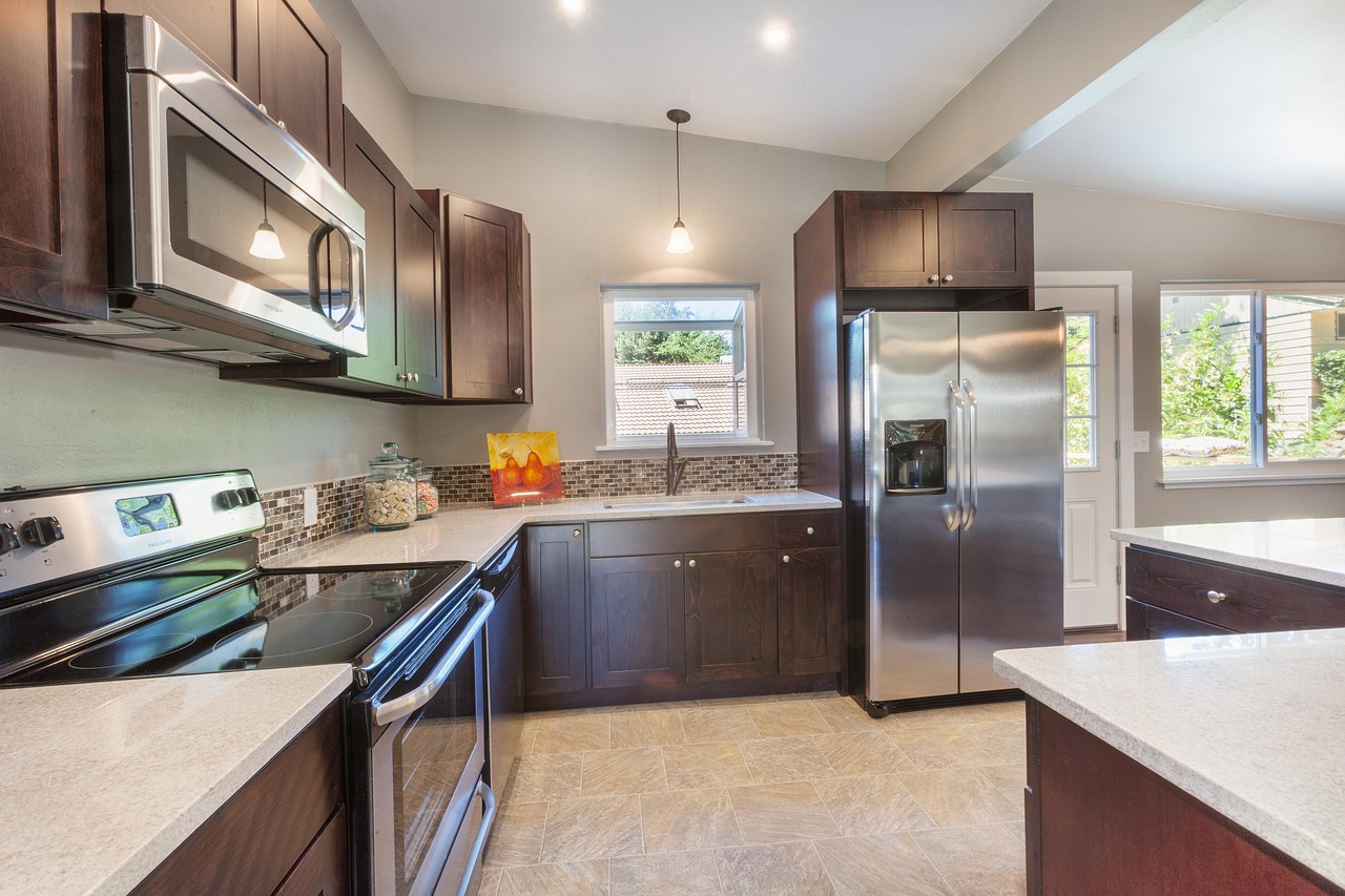Modern kitchen remodel with dark cabinets, stainless steel appliances, and mosaic backsplash in Richmond, Virginia