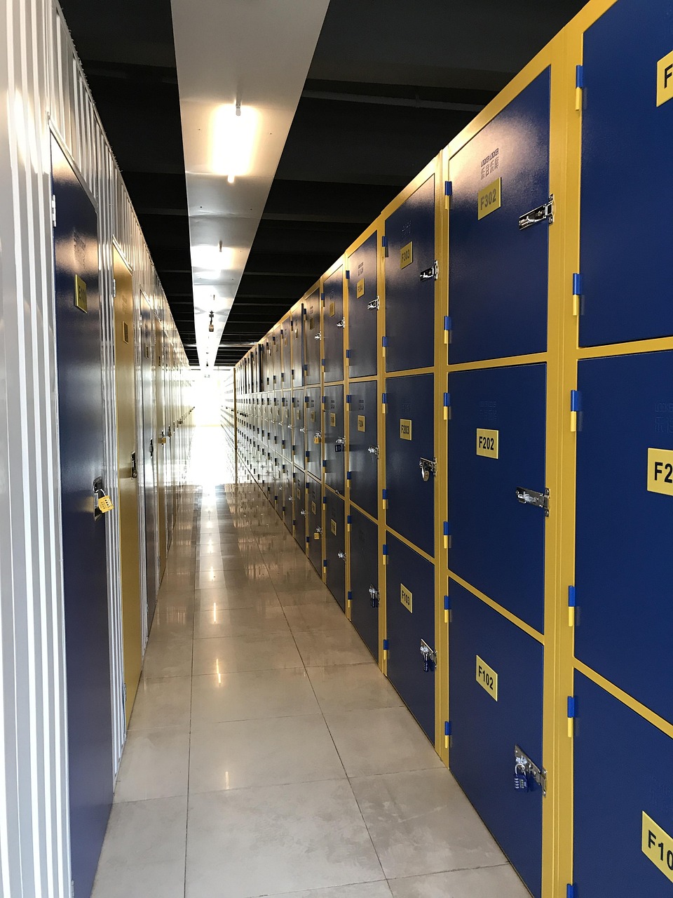 Modern self-storage facility conversion featuring blue and yellow storage units, polished concrete floors, and efficient layout in a converted warehouse in Petersburg, Virginia